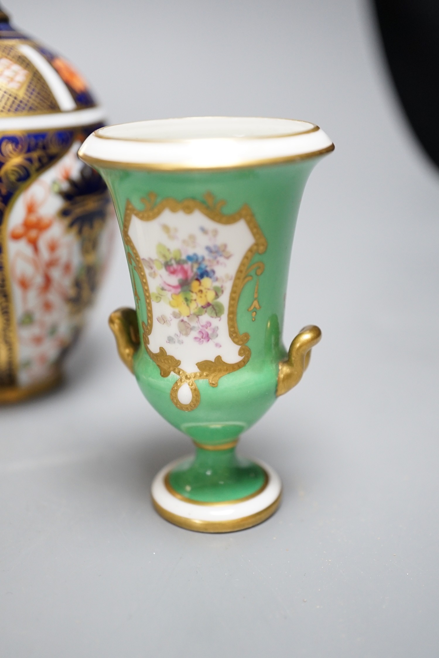 A Royal Crown Derby vase of baluster shape painted with pattern 1128, a two handled loving cup, with 1128, an RCD campana vase with green ground painted with flowers, two Derby King Street toads and a King Street octagon